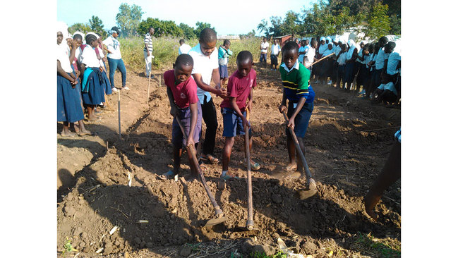 Pupils are preparing a school garden in Tanzania. Pupils are preparing a school garden in Tanzania.